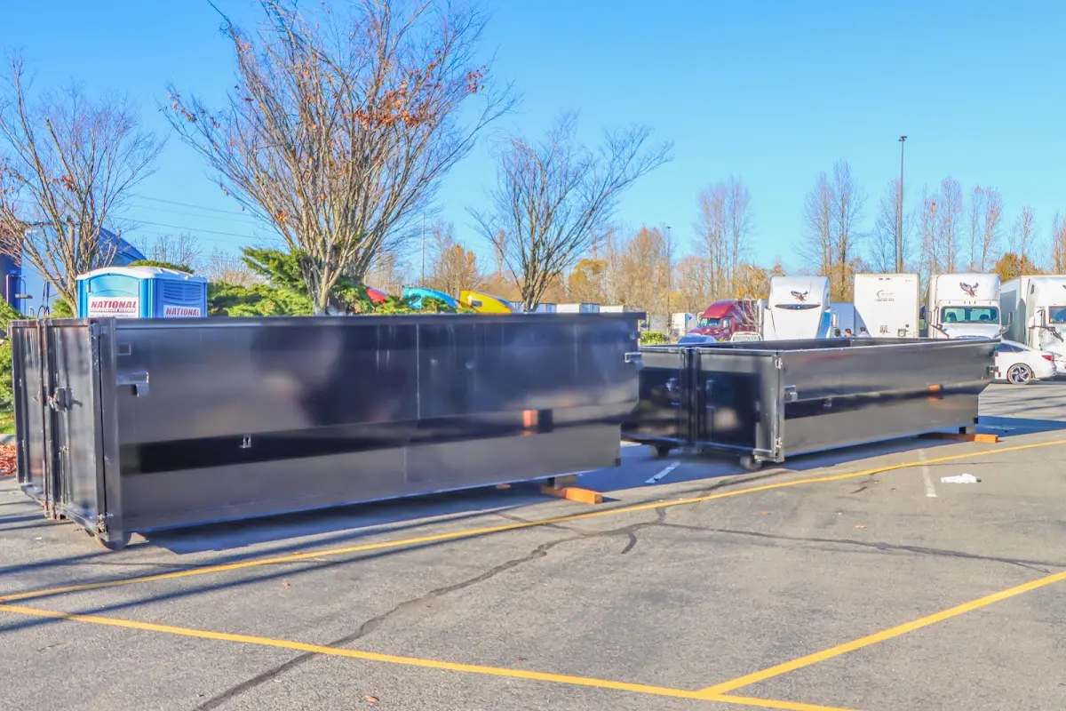 Professional dumpster rental service with roll-off container on residential driveway in Mission Bend